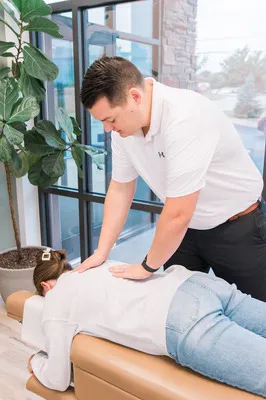 Chiropractor Springfield MO Tyler Alsup Adjusting Woman's Back